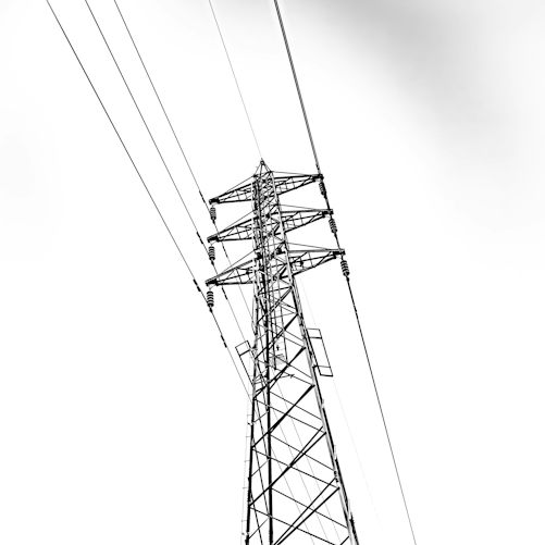 Black-and-white photograph of overhead electricity lines, illustrating grid infrastructure rather than a project financed by the EIB–BNP Paribas agreement.