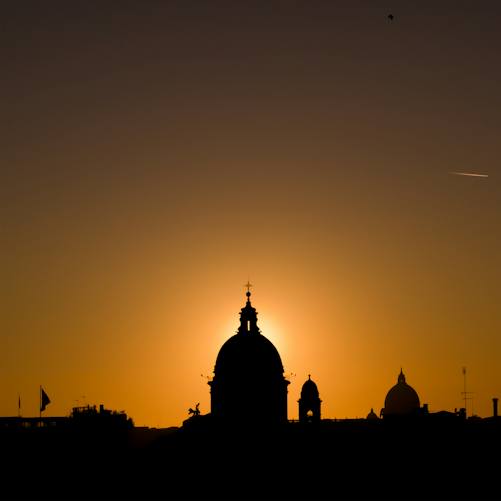 An illustrative sunset view of Rome's architecture representing Italy's public-finance debate; not the October 12 Bank of Italy parliamentary hearing.