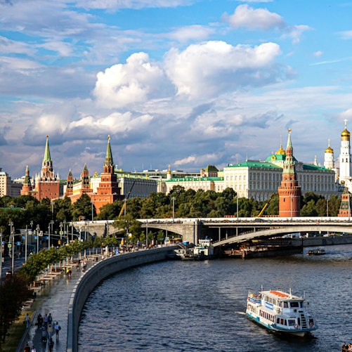 The Moscow Kremlin and a riverboat on the Moskva River.